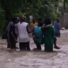 Hurricane Sandy In Haiti, Beeing Carried By Several People
