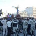 Kita Nago being carried by Haitian Police