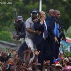 Jean Bertrand Aristide blowing kisses from the rooftop of his SUV