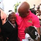 Prime Minister Laurent Lamothe talking with two young children
