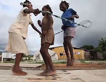 Three Children Involver In A Rope Game