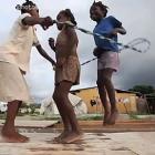 Three Children Involver In A Rope Game