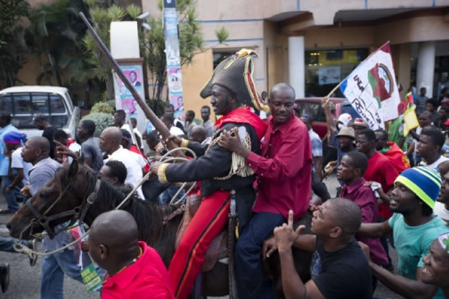 Moise Jean Charles on horseback riding during Protest