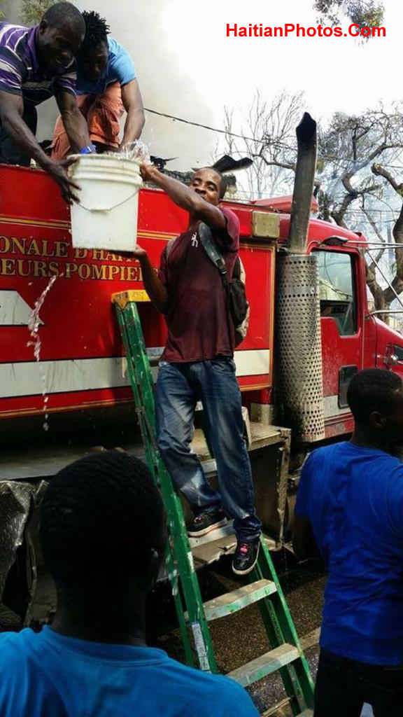 Firefighters fighting fire in Haiti by the bucket