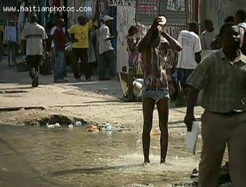Gentleman Taking Shower In The Street In Haiti