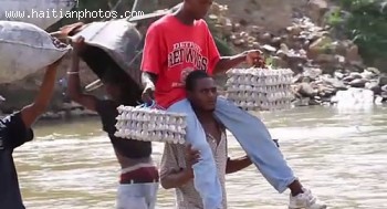 Haitians Crossing The Border Between Haiti And Dominican Republic With Egg Carton